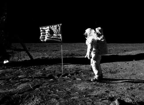 Astronaut Buzz Aldrin planting an American flag on the moon.